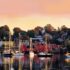 a beautiful sunset over Lunenburg waterfront showing all the sail boats.